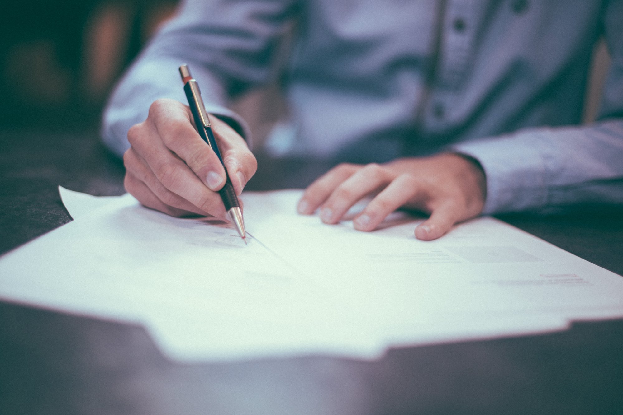 A professional filling out paperwork A professional filling out paperwork