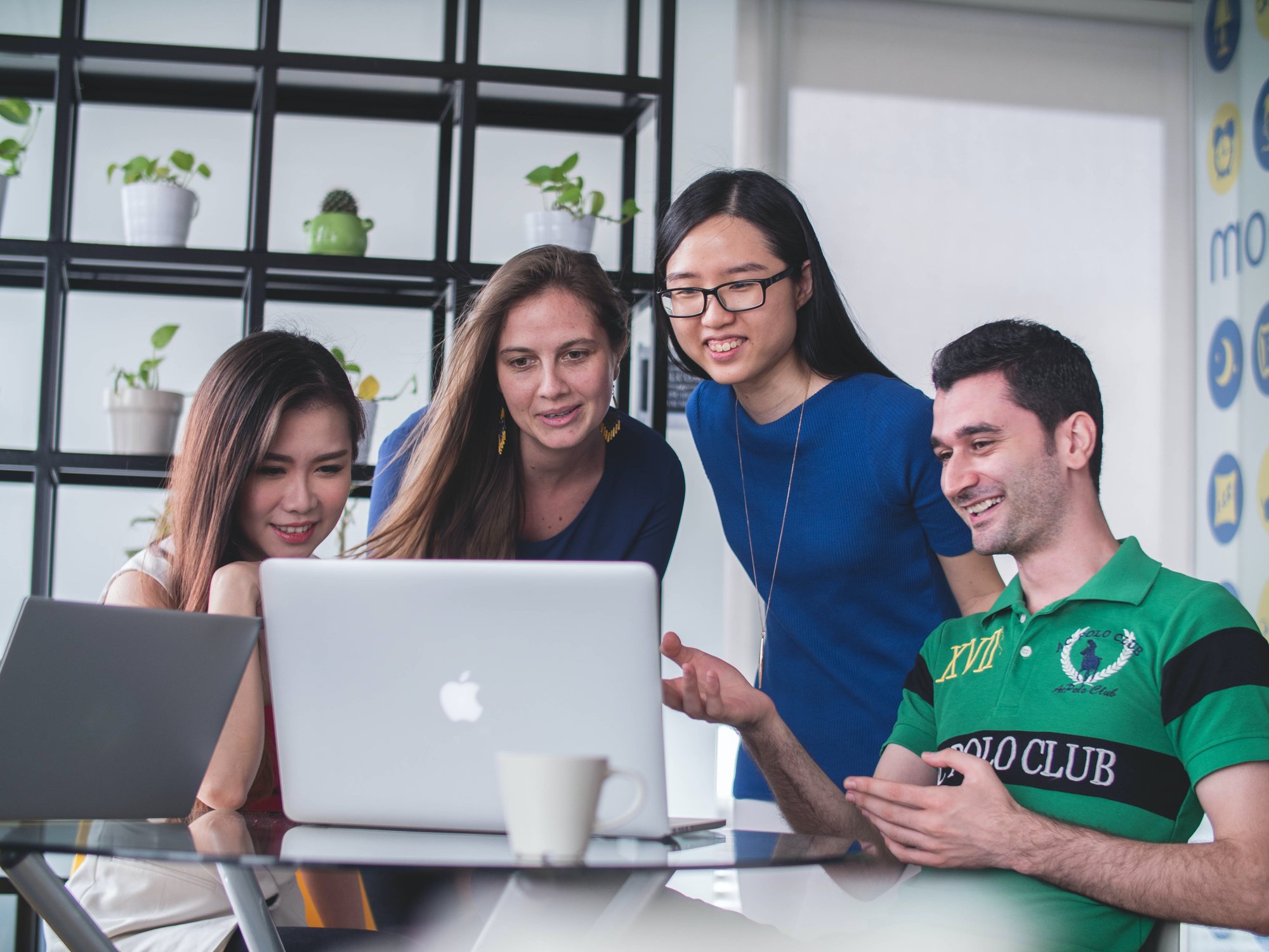 A group looking at a laptop screen A group looking at a laptop screen