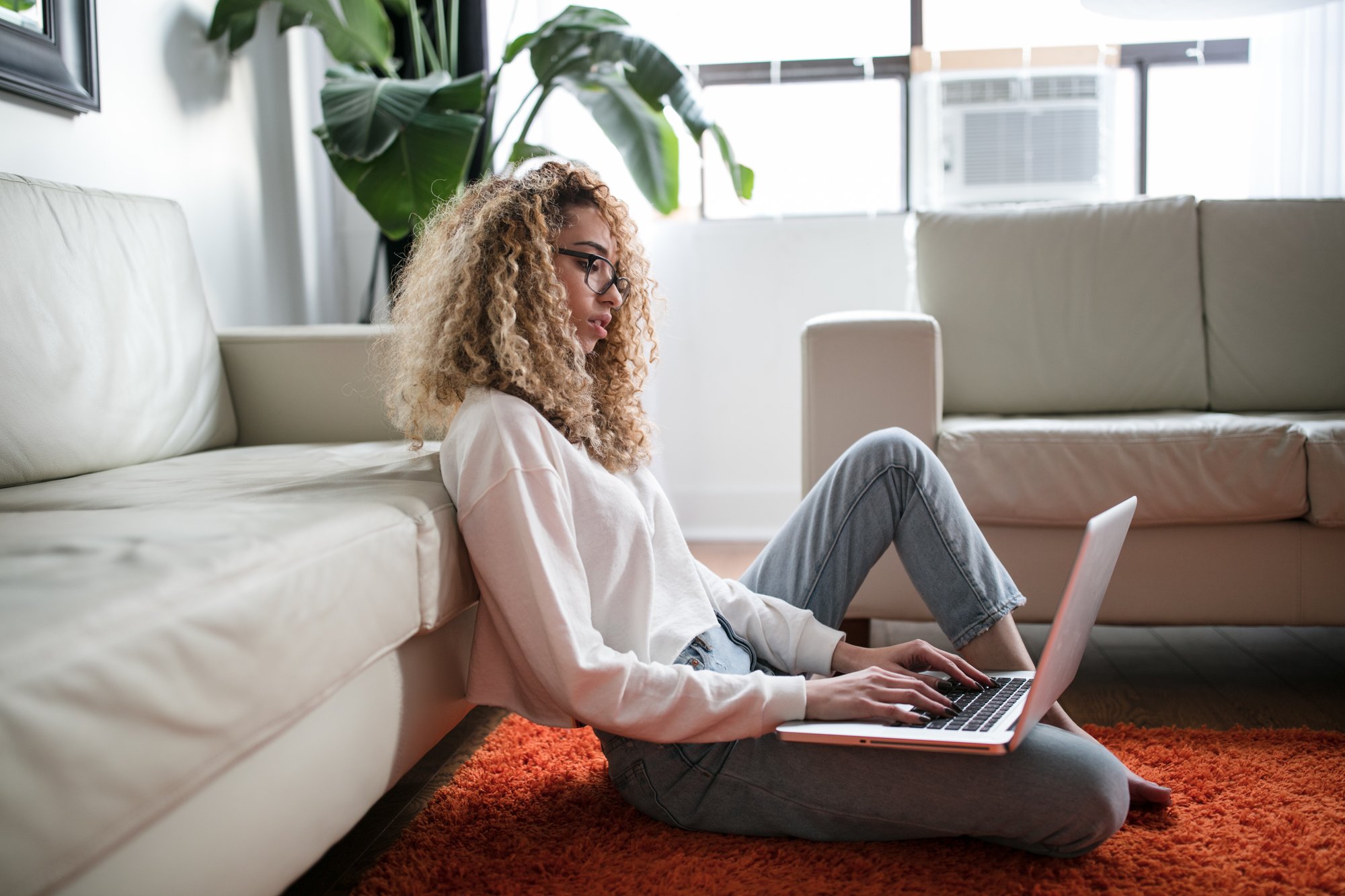 Woman lounging on the floor with laptop